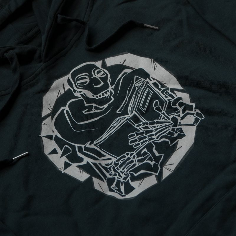 Black hoodie, front print of a skeleton reading a book inside a cracked circle