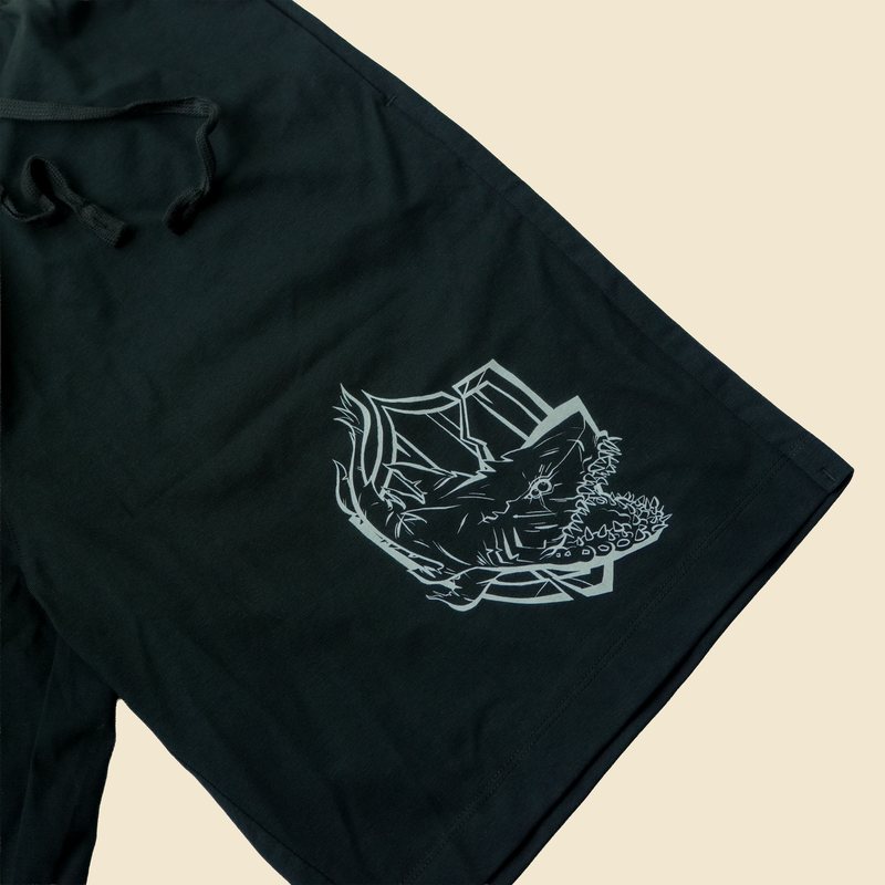 Black shorts with a creature crest print on the leg
