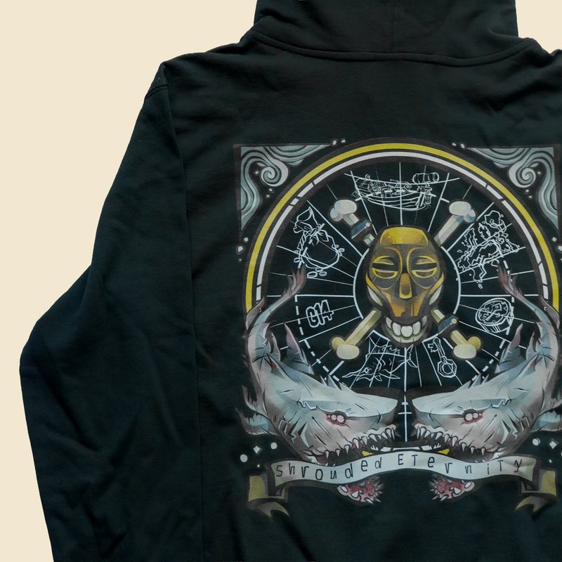 Black hoodie, back print of a gold masked skull over a compass with sharks and a Shrouded Eternity banner